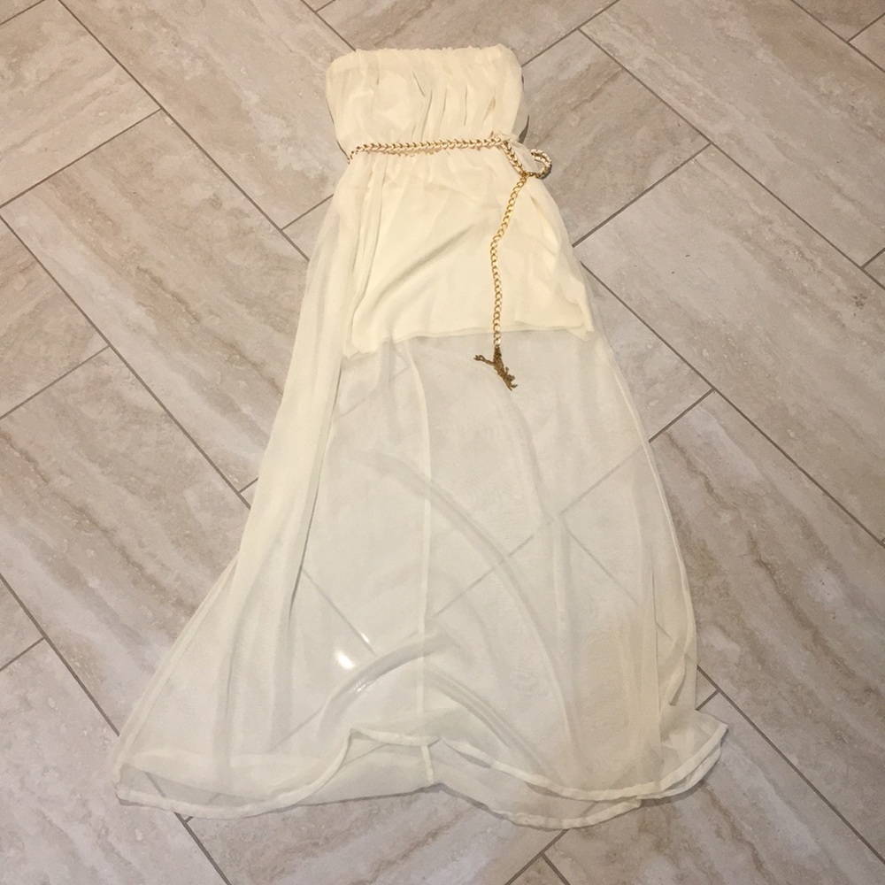 Creme-colored strapless maxi dress with chain belt